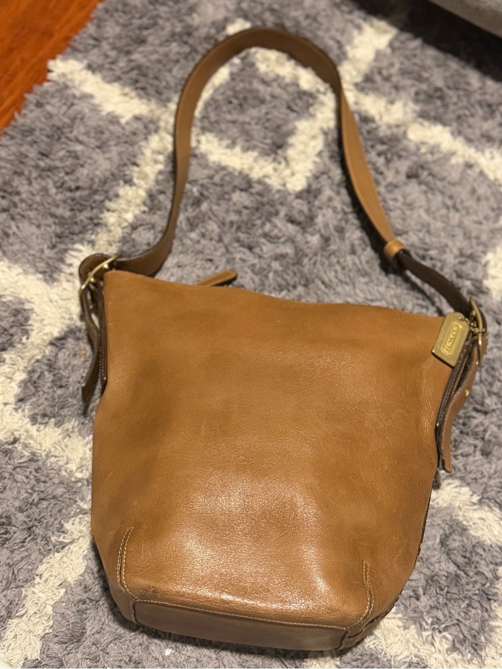Coach tan shoulder bag with gold brass hang tag